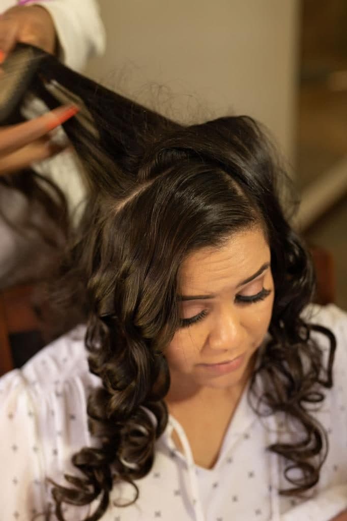Glossy curls being styled